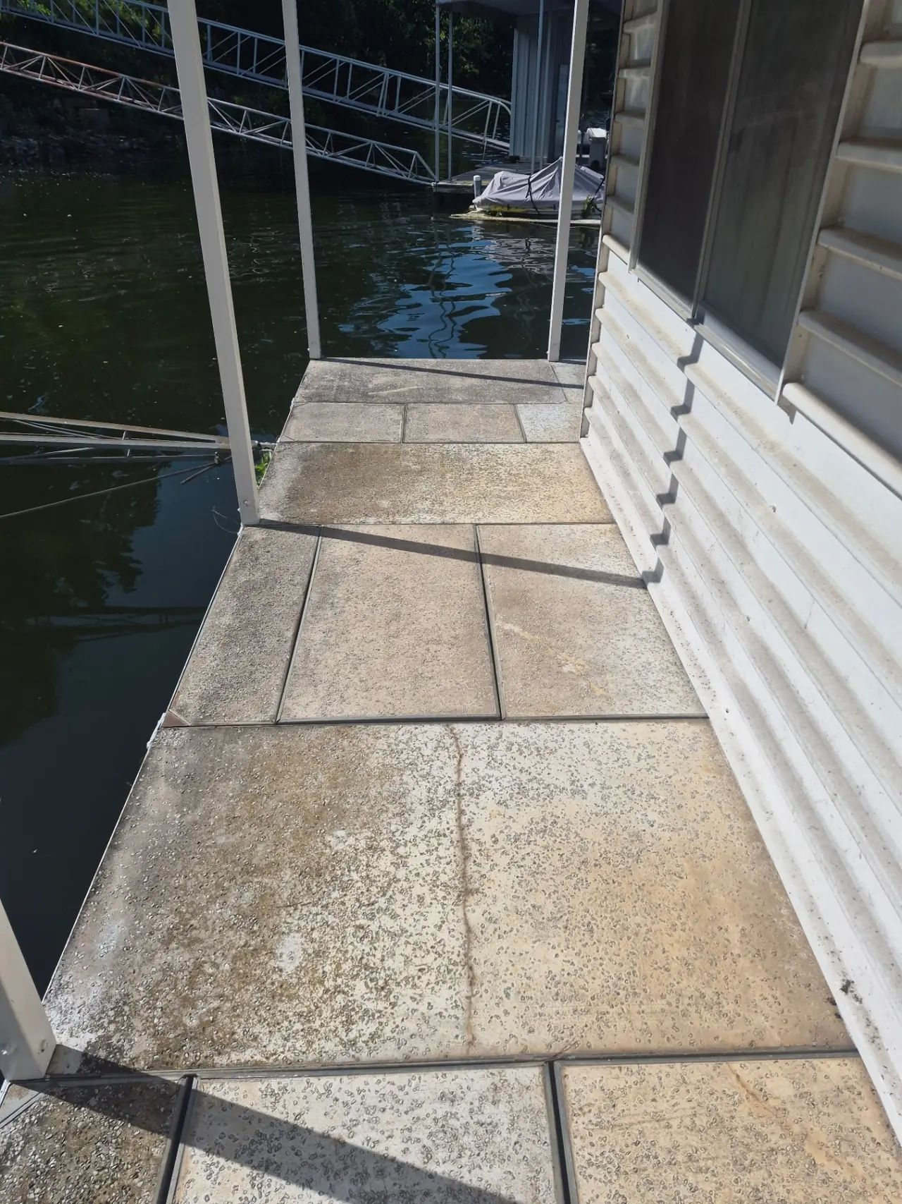 Boathouse & Walkway Restoration — Concrete pavers before cleaning.