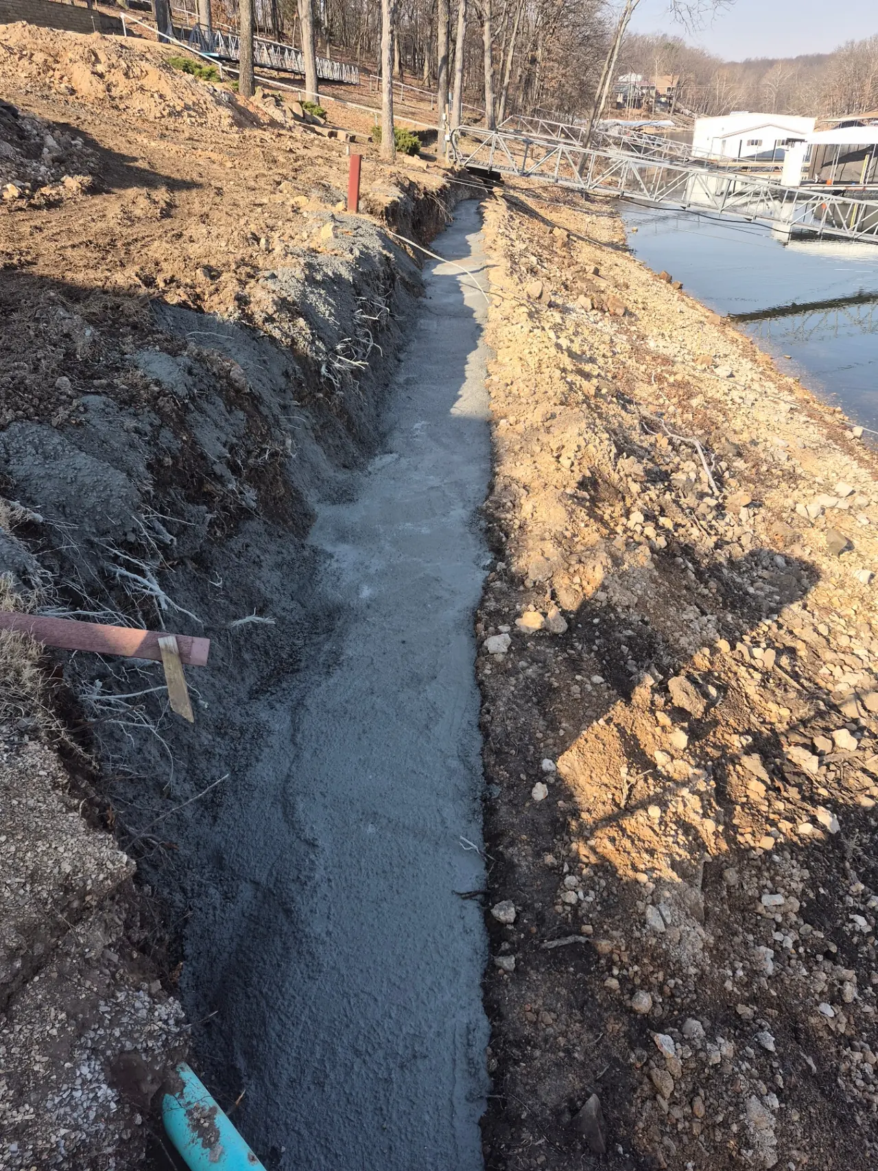 Grand Lake Seawall Rebuild — Concrete footing poured along the new wall line.
