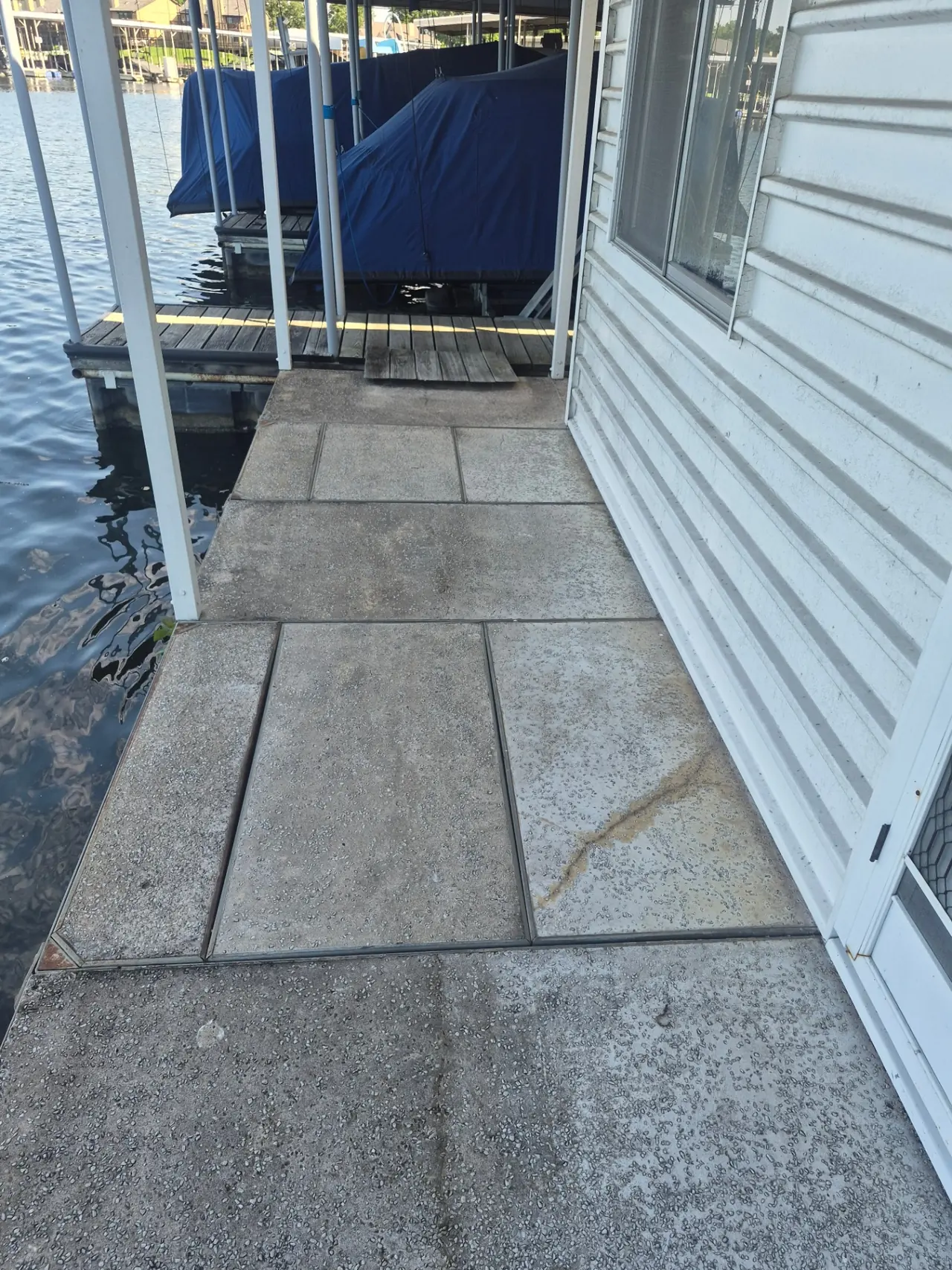 Boathouse & Walkway Restoration — Boat-slip concrete dulled by years of buildup.