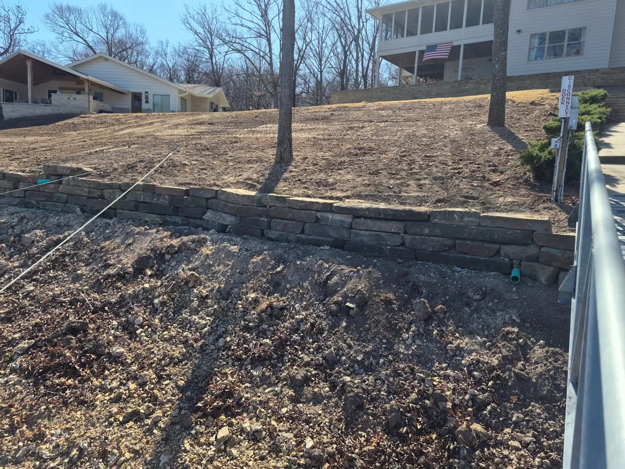 Lakefront Sod & Grading — Finished grade along the retaining wall.