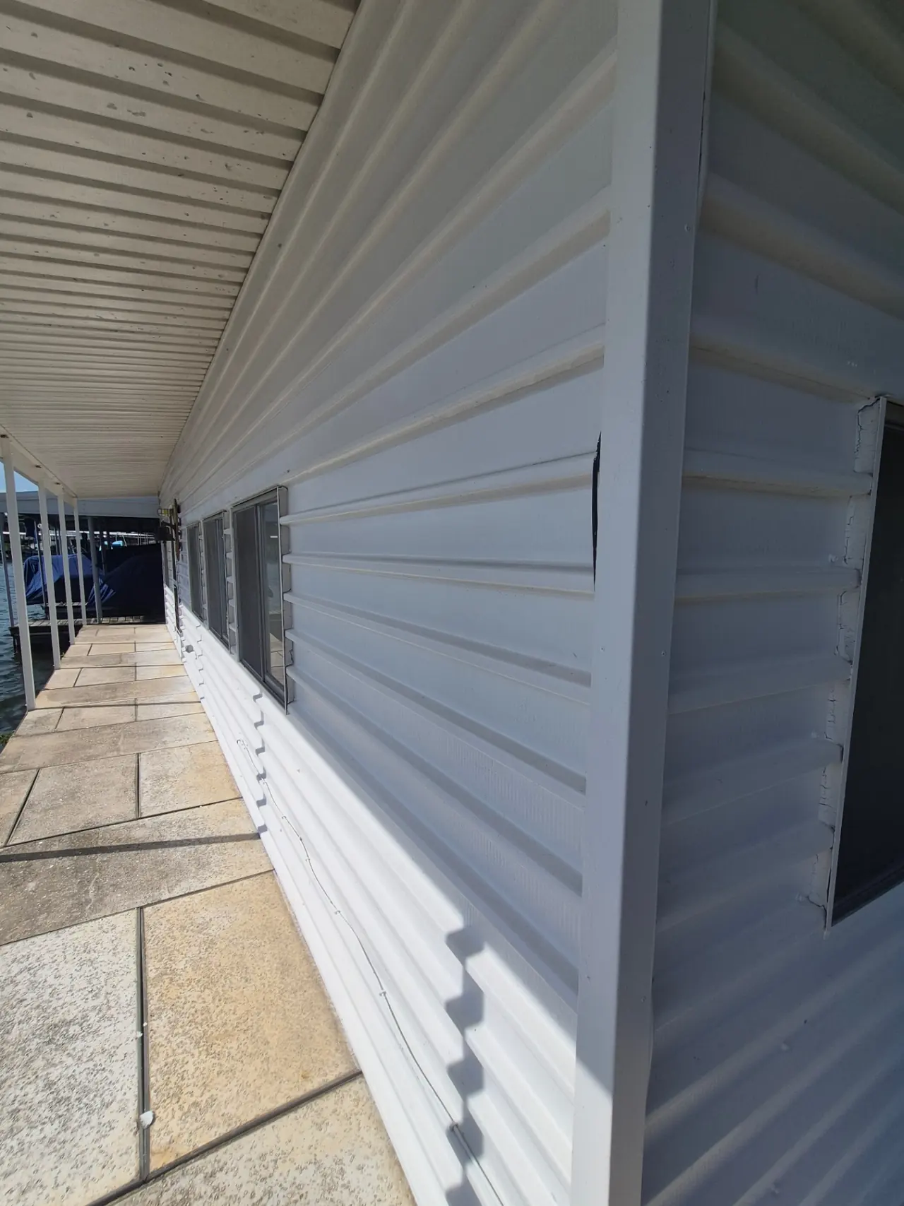 Boathouse & Walkway Restoration — Lakeside walkway cleaned and sealed.