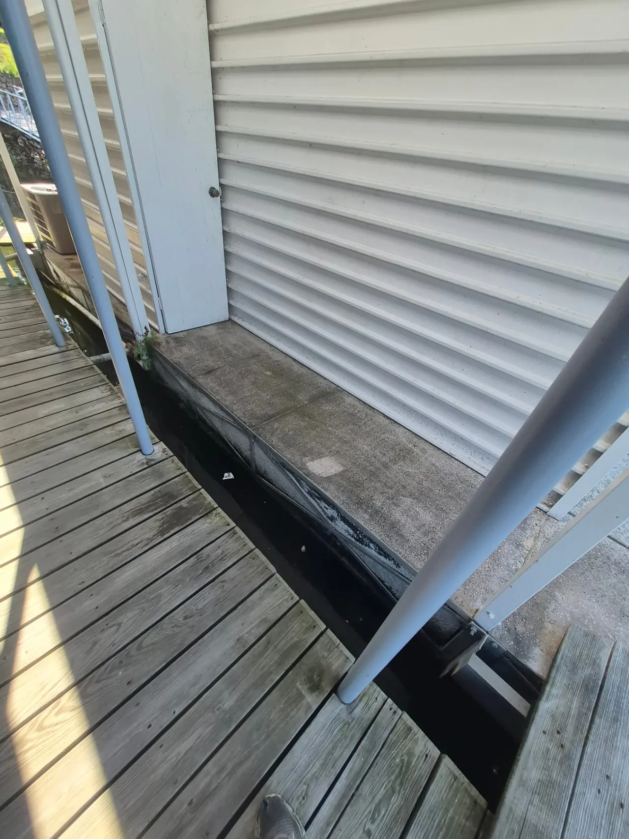 Boathouse & Walkway Restoration — Dock concrete brightened and rinsed.