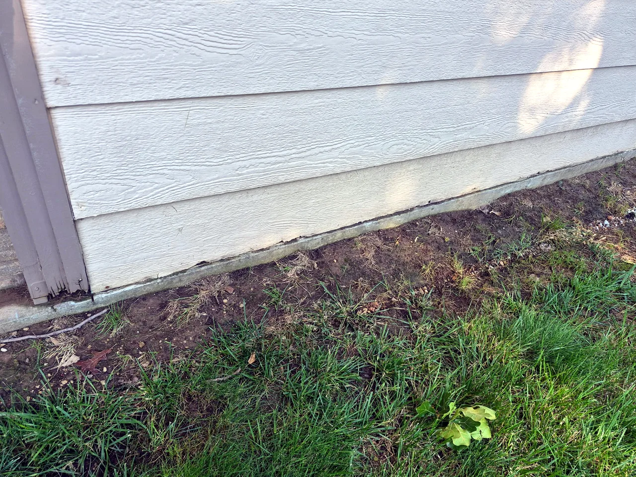 Weathered Siding at Foundation Line — Before — Grand Lake, OK