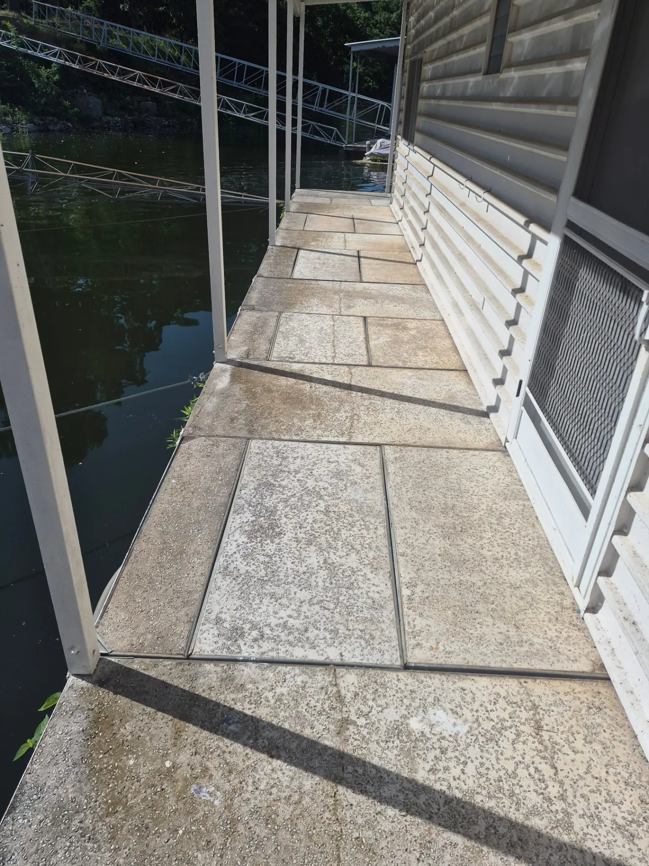 Boathouse & Walkway Restoration — Boathouse walkway covered in black algae.